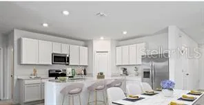 a kitchen with stainless steel appliances kitchen island granite countertop a sink and cabinets
