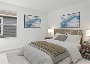 a bedroom with a bed and the painting on the wall