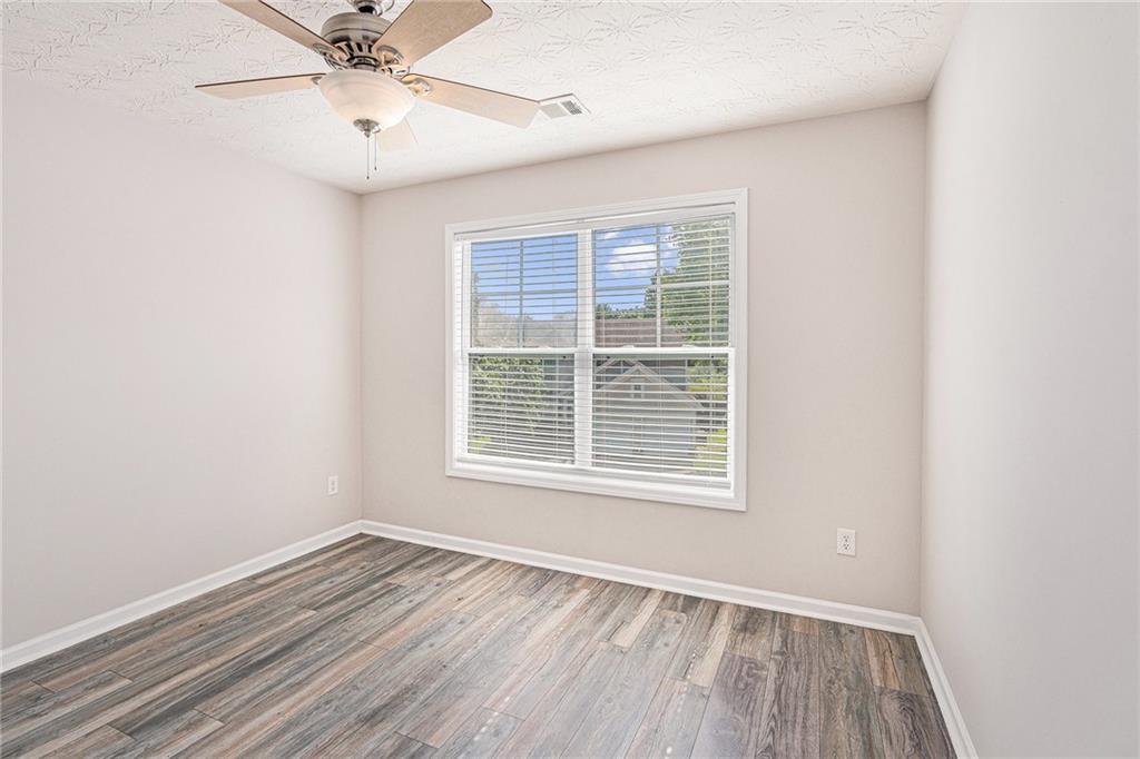 1576 Thornwick Trace Stockbridge, GA 30281 - Photo 27 of 30 a view of an empty room with wooden floor and a window