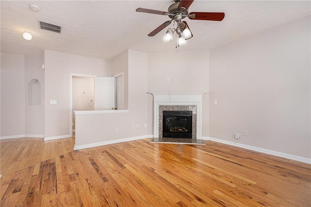 1576 Thornwick Trace Stockbridge, GA 30281 - Photo 4 of 30 a view of empty room with wooden floor and fan