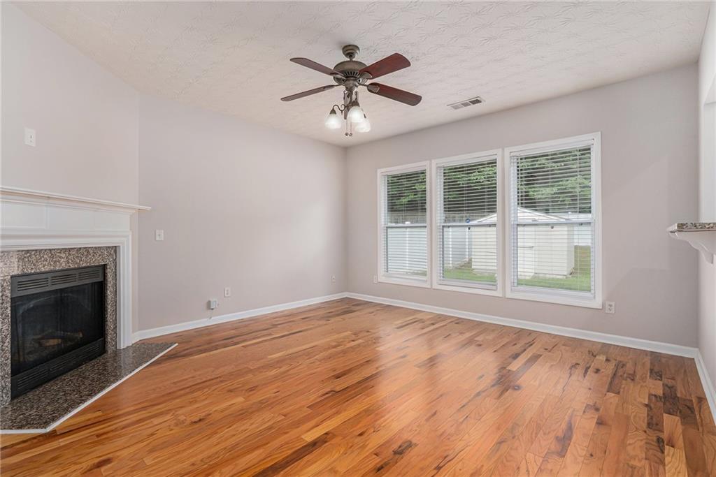 1576 Thornwick Trace Stockbridge, GA 30281 - Photo 5 of 30 a view of an empty room with wooden floor and a window