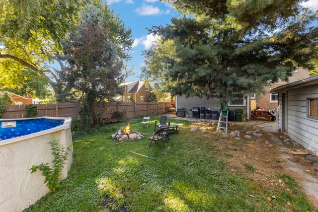 a backyard of a house with table and chairs