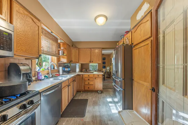 a kitchen with a sink stove and refrigerator
