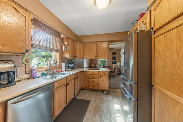 a kitchen with sink cabinets and refrigerator
