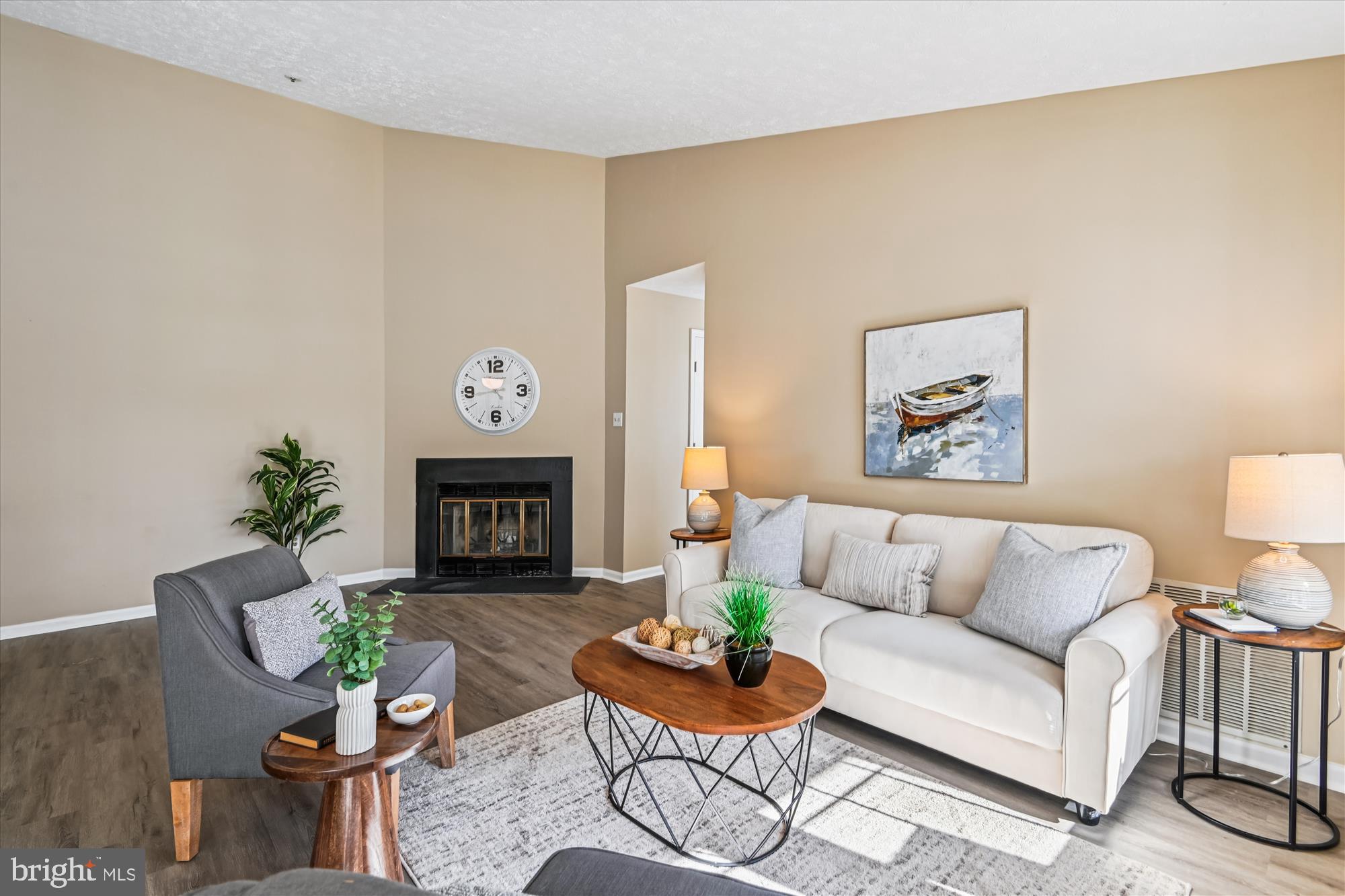 717 Deering Road, Unit 5L Pasadena, MD 21122 - Photo 11 of 29 a living room with furniture a fireplace and wall paintings