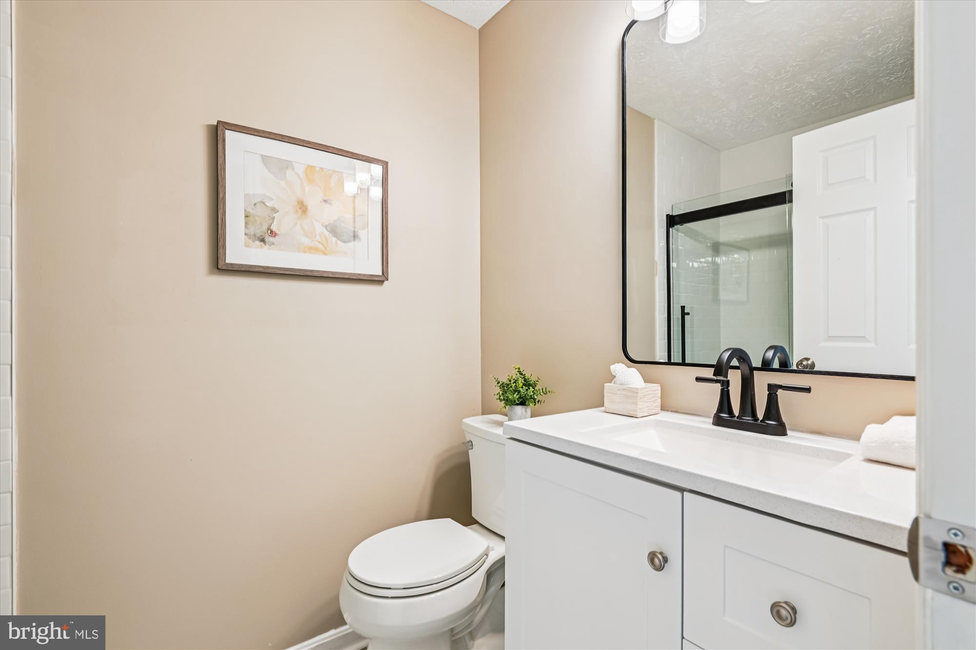 717 Deering Road, Unit 5L Pasadena, MD 21122 - Photo 19 of 29 a bathroom with a toilet a sink and mirror