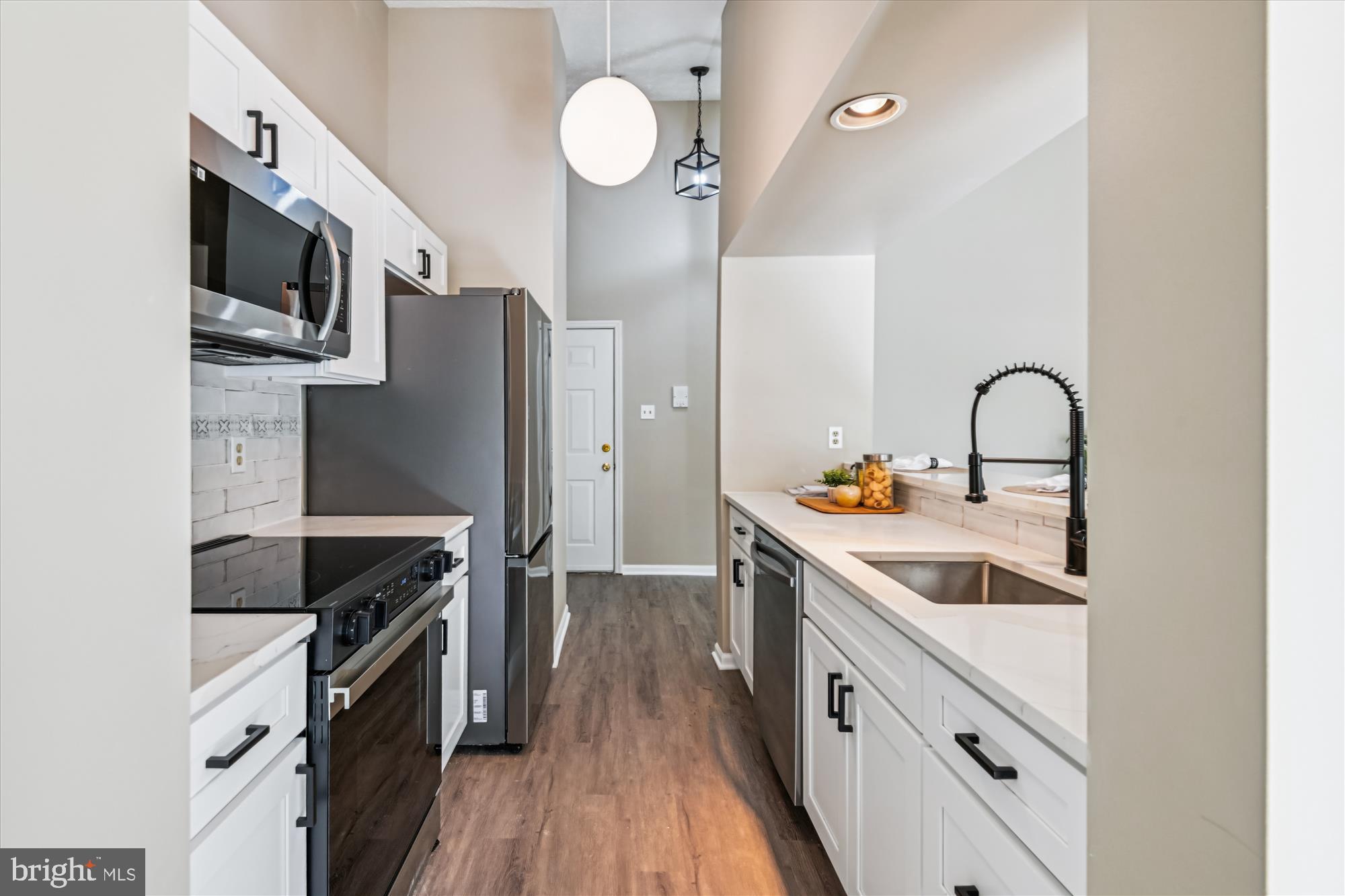 717 Deering Road, Unit 5L Pasadena, MD 21122 - Photo 3 of 29 a kitchen with stainless steel appliances granite countertop a sink stove and refrigerator
