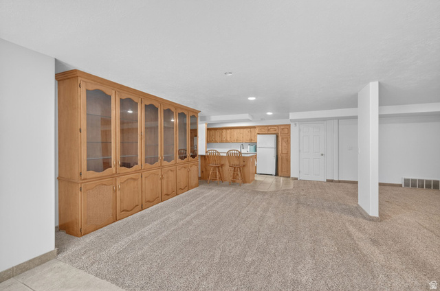 883 East 700 South Springville, UT 84663 - Photo 34 of 59 Expansive lower-level space featuring a built-in display cabinet with glass-front doors, recessed lighting, and plush carpet flooring