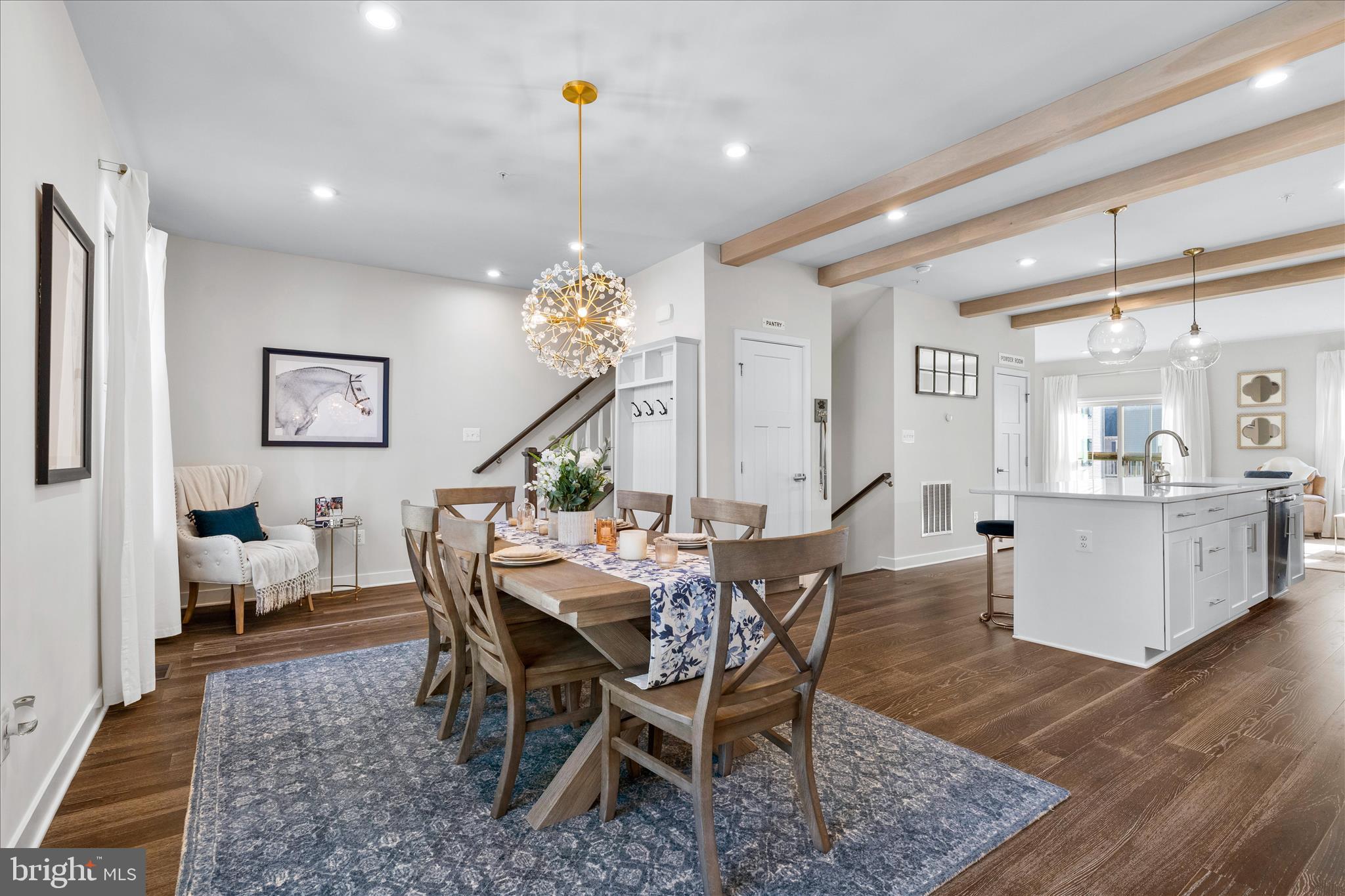 10327 Quillback Street New Market, MD 21774 - Photo 15 of 50 a view of a dining room and livingroom with furniture wooden floor a rug a painting and a chandelier