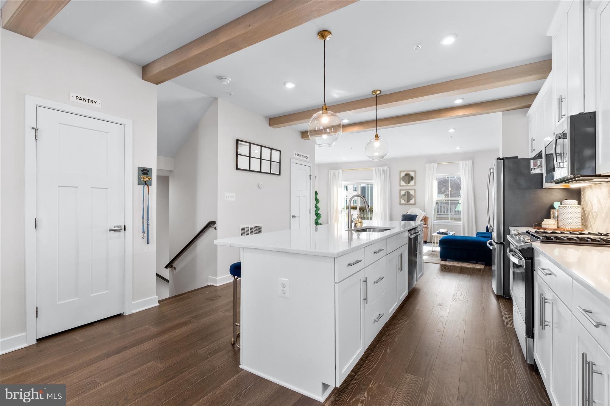 10327 Quillback Street New Market, MD 21774 - Photo 9 of 50 a large white kitchen with a large window a stove a sink and a refrigerator