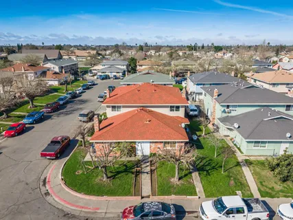 an aerial view of residential houses with yard
