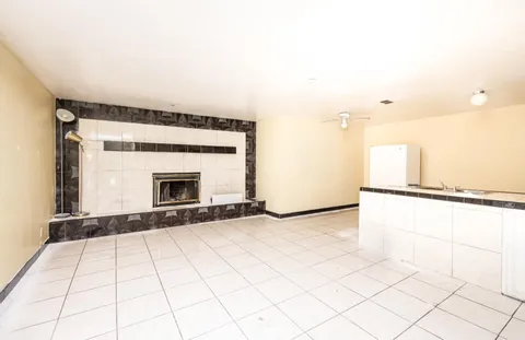 a view of an empty room with cabinet and a window