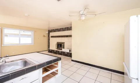 a kitchen with a sink and a stove top oven