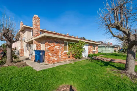 a front view of a house with a garden