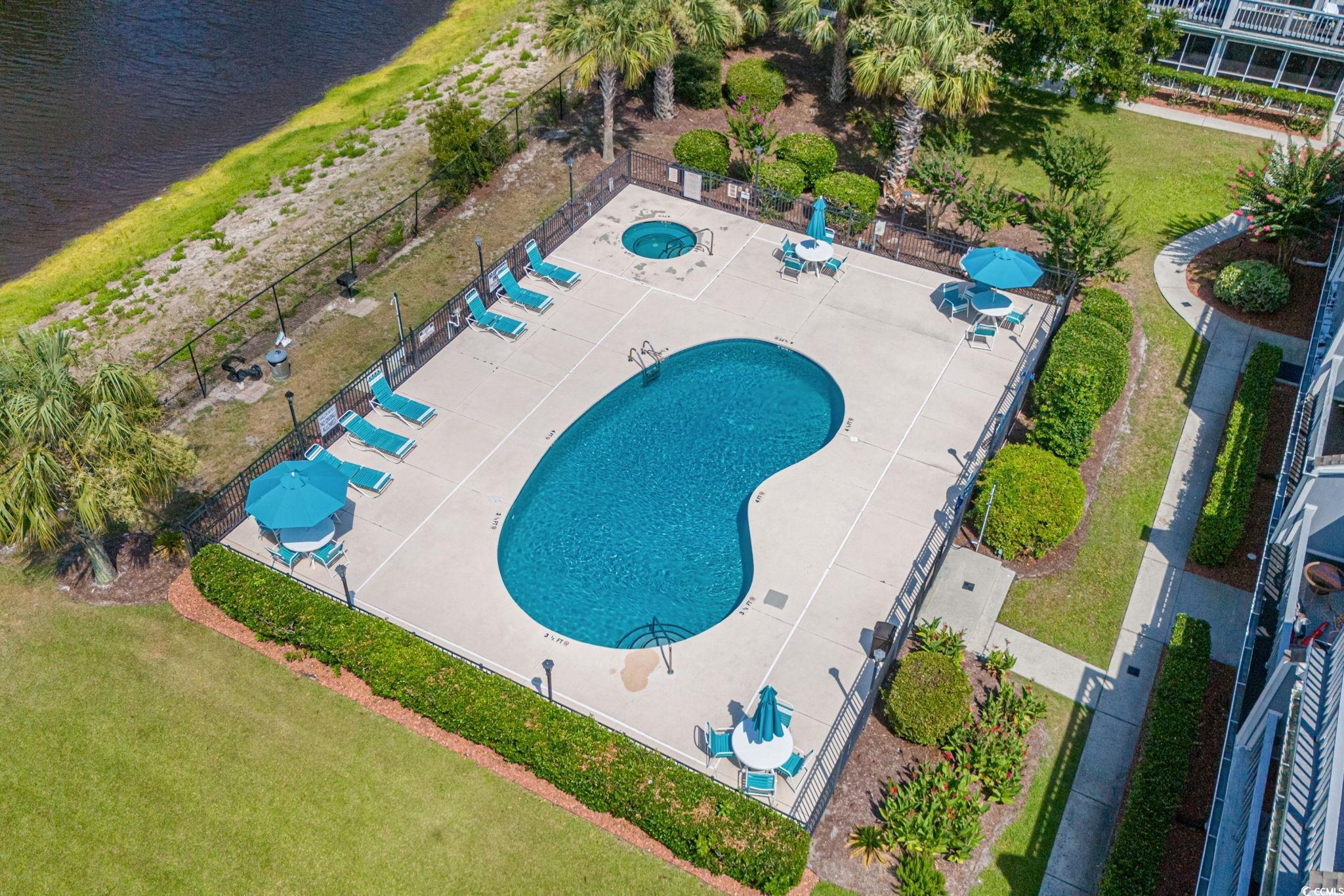 1890 Colony Drive, Unit 16I Myrtle Beach, SC 29575 - Photo 18 of 35 Bird's eye view of a pool and a nearby body of water