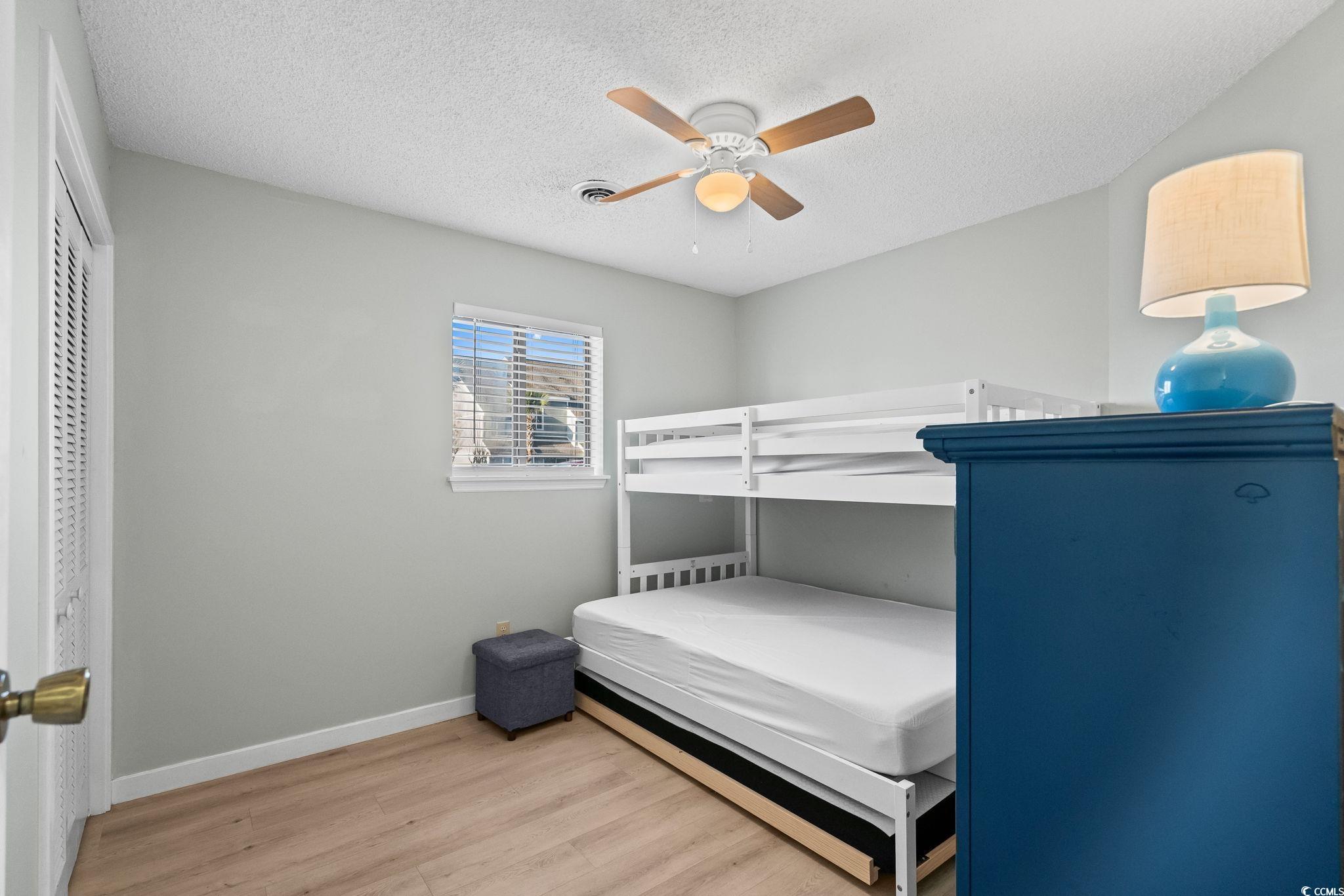 1890 Colony Drive, Unit 16I Myrtle Beach, SC 29575 - Photo 3 of 35 Bedroom featuring a textured ceiling, light wood-style flooring, and ceiling fan