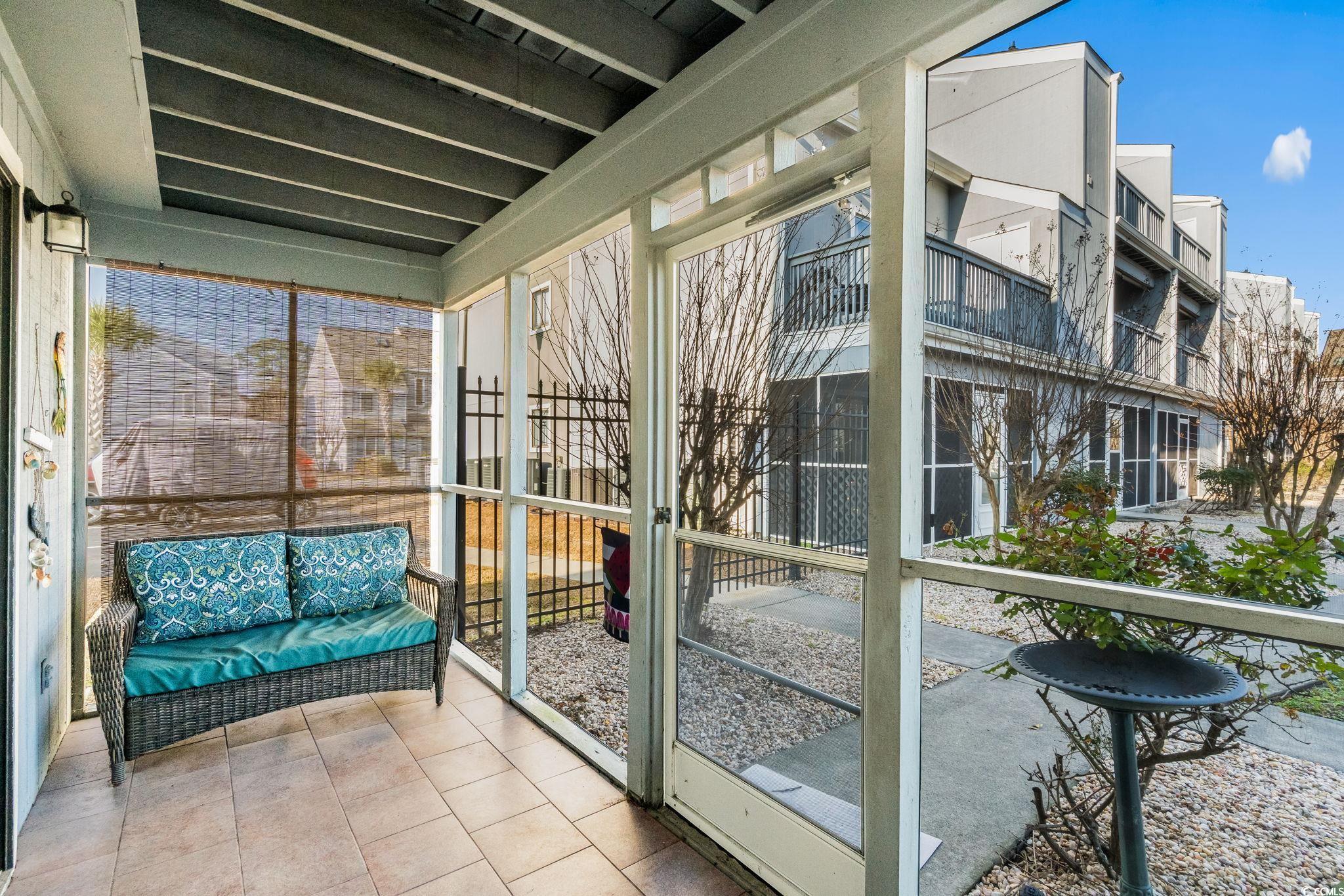 1890 Colony Drive, Unit 16I Myrtle Beach, SC 29575 - Photo 9 of 35 Sunroom / solarium featuring plenty of natural light and a patio area