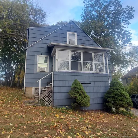 a view of a brick house with a yard