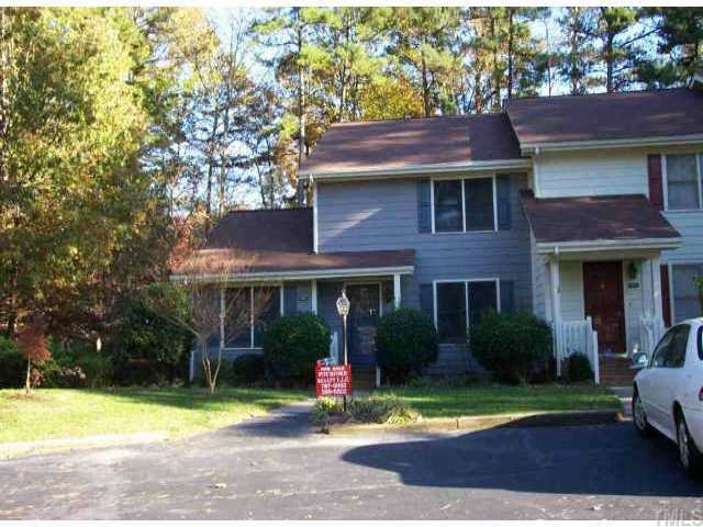1526 Edgeside Court Raleigh, NC 27609 - Photo 1 of 1 a view of a brick house with a yard plants and large tree