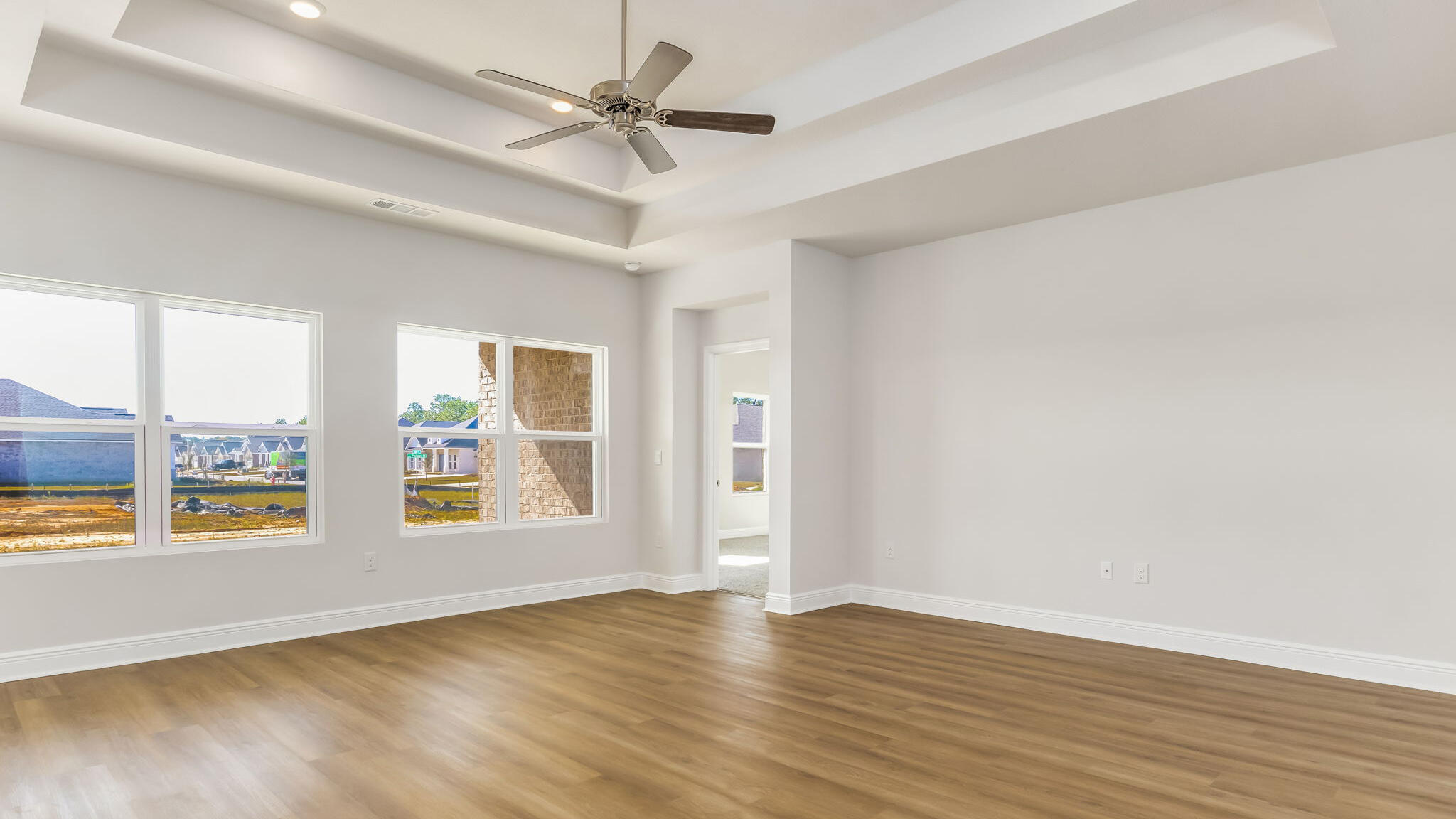 5612 Thatcher Road Crestview, FL 32539 - Photo 7 of 30 an empty room with window and wooden floor