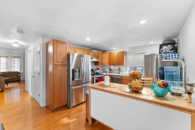 a kitchen filled with stainless steel appliances granite countertop a refrigerator and a sink