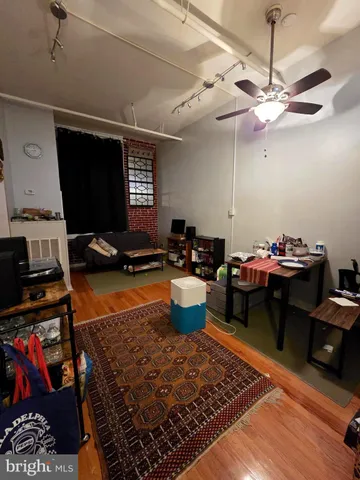 a living room with furniture a rug and a chandelier