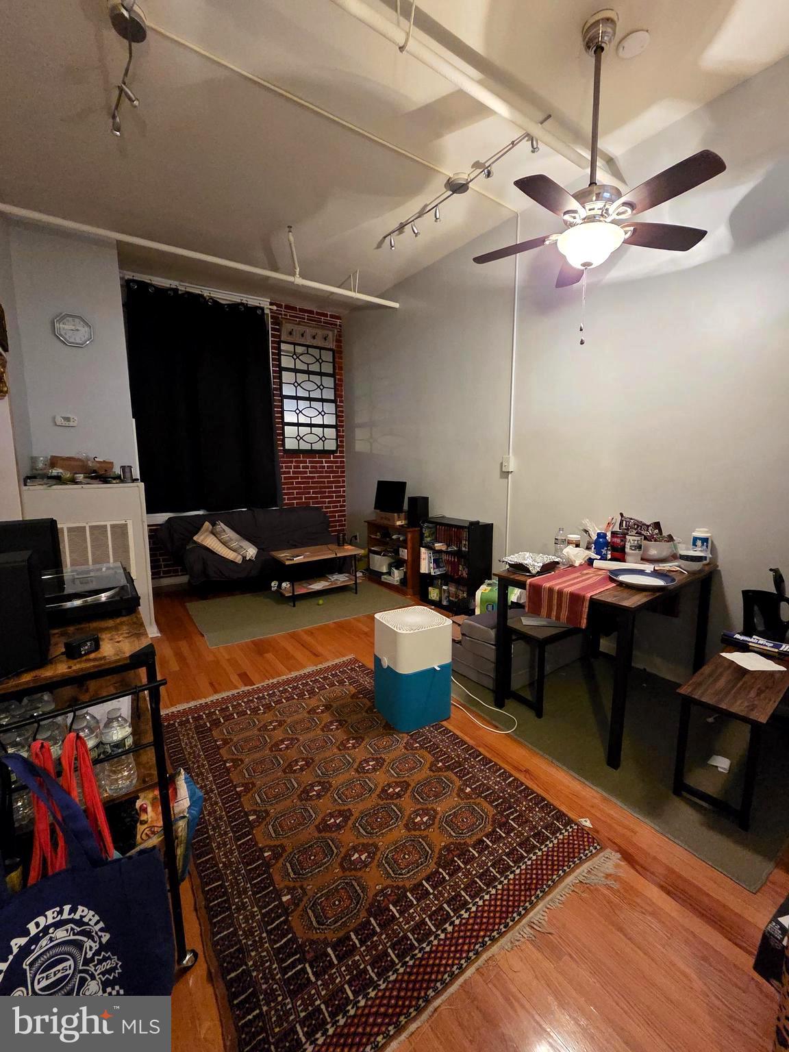 1010 Race Street, Unit 8H Philadelphia, PA 19107 - Photo 11 of 15 a living room with furniture a rug and a chandelier
