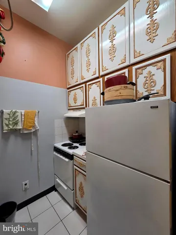 a kitchen with stainless steel appliances a refrigerator and a stove top oven