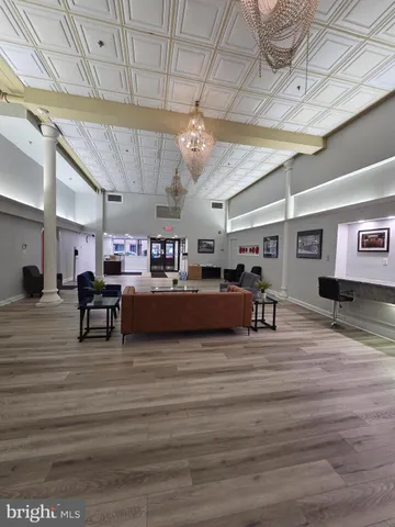 a living room with lots of furniture and a chandelier