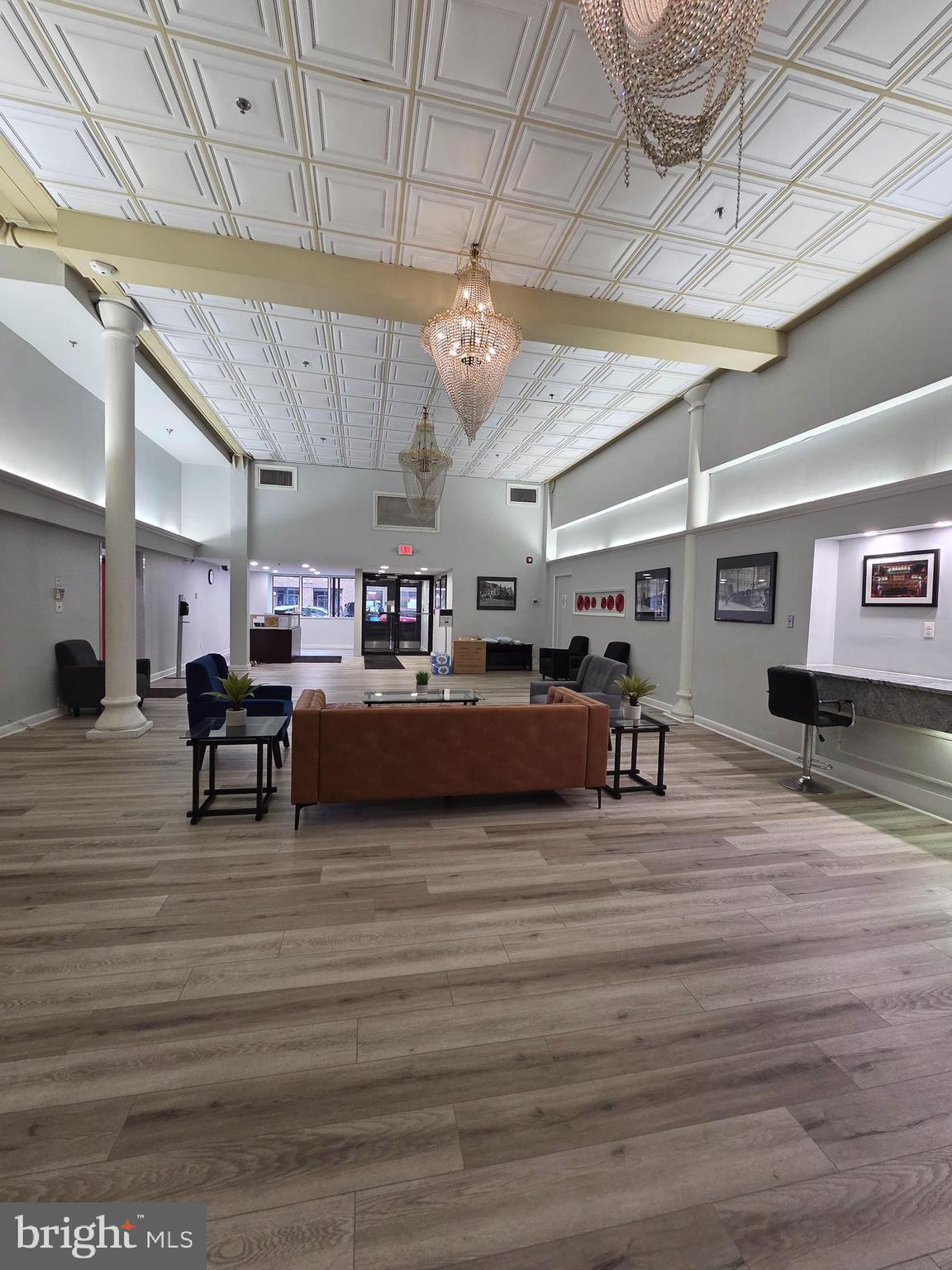 1010 Race Street, Unit 8H Philadelphia, PA 19107 - Photo 6 of 15 a living room with lots of furniture and a chandelier