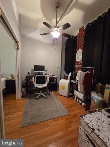 a bedroom with furniture and a mirror