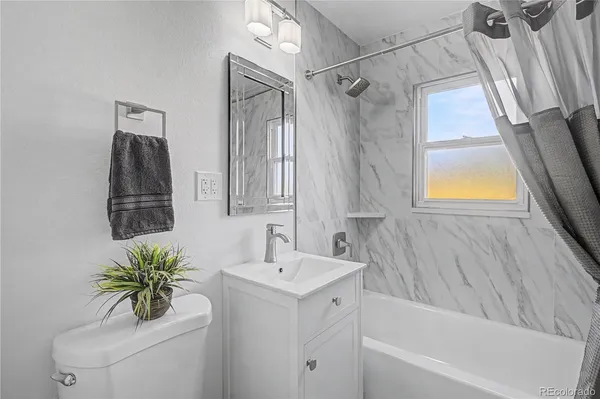 a bathroom with a bathtub a sink and a vanity