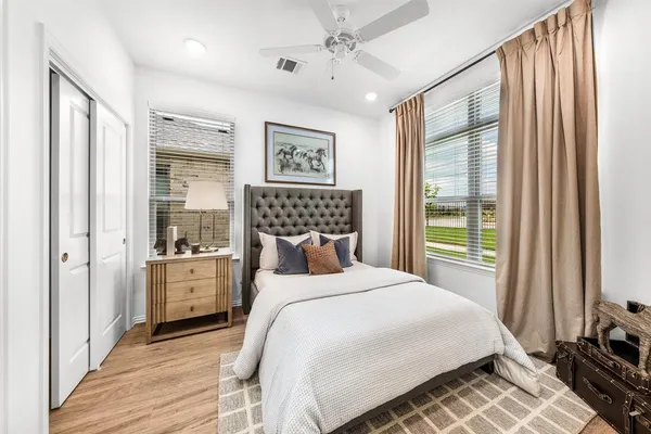 a bedroom with a large bed and a window