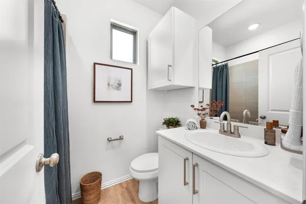 a bathroom with a toilet sink and mirror