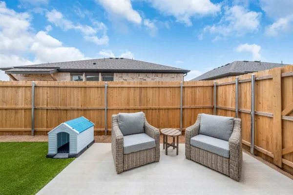 a balcony with furniture and a garden