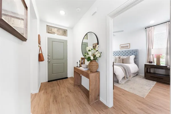 a bedroom with furniture and wooden floor