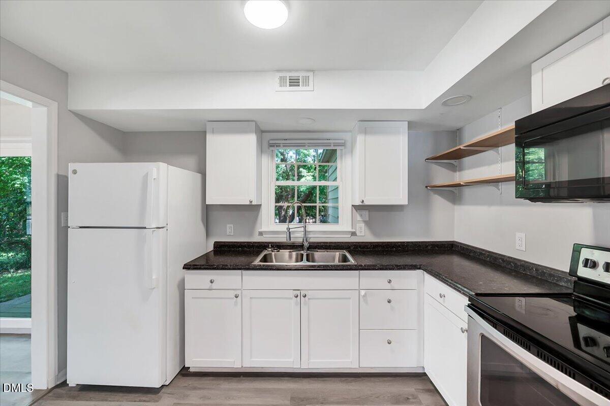 3408 Atlantic Avenue Raleigh, NC 27604 - Photo 28 of 48 a kitchen with white cabinets and white appliances