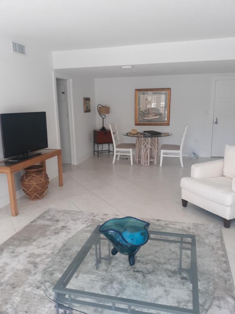 2780 South Ocean Boulevard, Unit 207 Palm Beach, FL 33480 - Photo 6 of 8 a living room with furniture and a flat screen tv