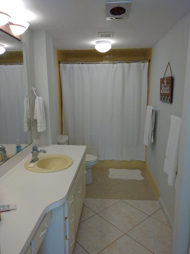 2780 South Ocean Boulevard, Unit 207 Palm Beach, FL 33480 - Photo 8 of 8 a bathroom with a granite countertop sink and a mirror