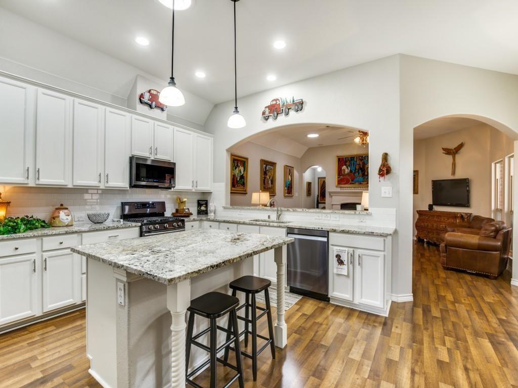 9962 Bell Rock Road Frisco, TX 75035 - Photo 7 of 28 a large kitchen with cabinets a sink and appliances