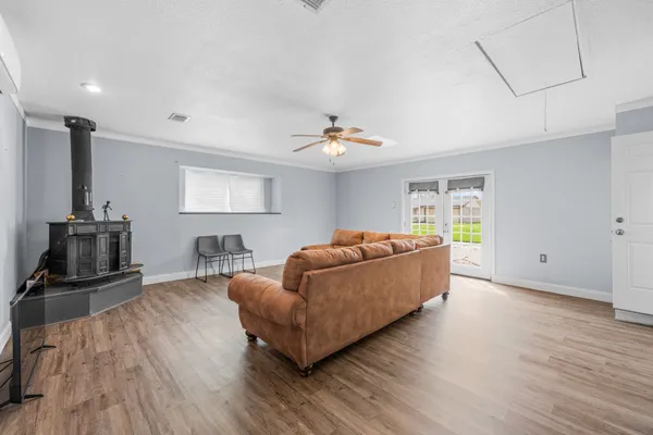 a living room with furniture and a ceiling fan