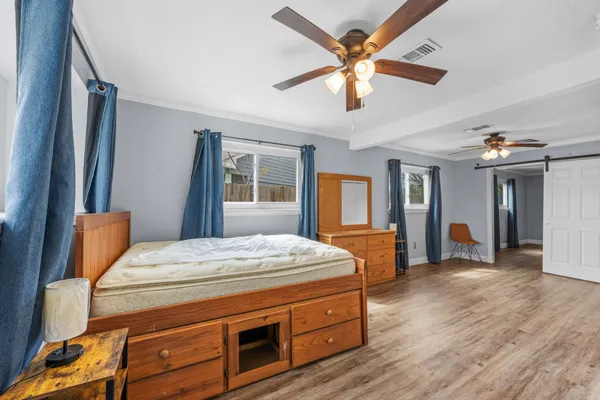 an empty room with wooden floor and a window