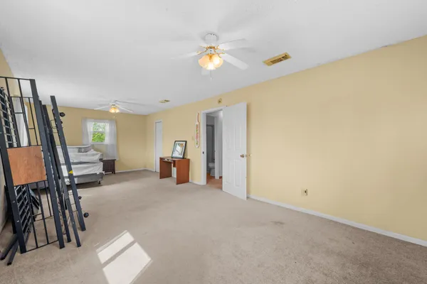 a view of empty room with ceiling fan