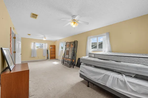 a view of empty room with ceiling fan