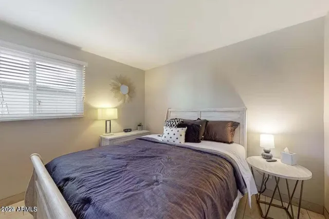 a bedroom with a bed and a table