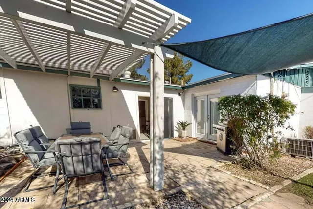 a backyard of a house with outdoor seating