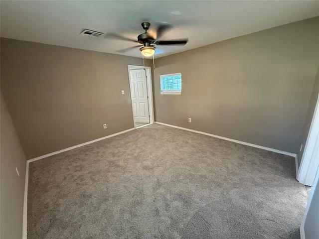 a view of room with window and ceiling fan