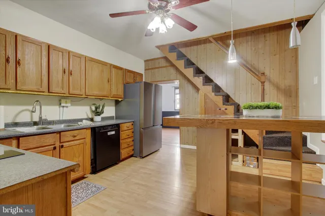 a kitchen with stainless steel appliances granite countertop wooden cabinets a sink and dishwasher