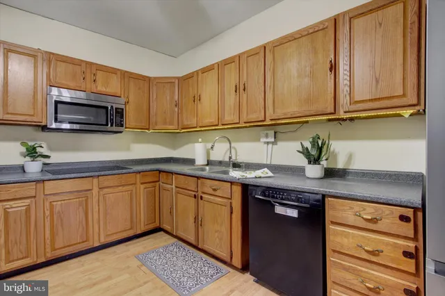 a kitchen with stainless steel appliances granite countertop a stove and a sink