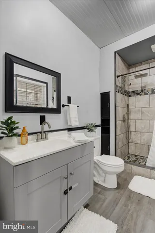 an empty room with a window and a ceiling fan